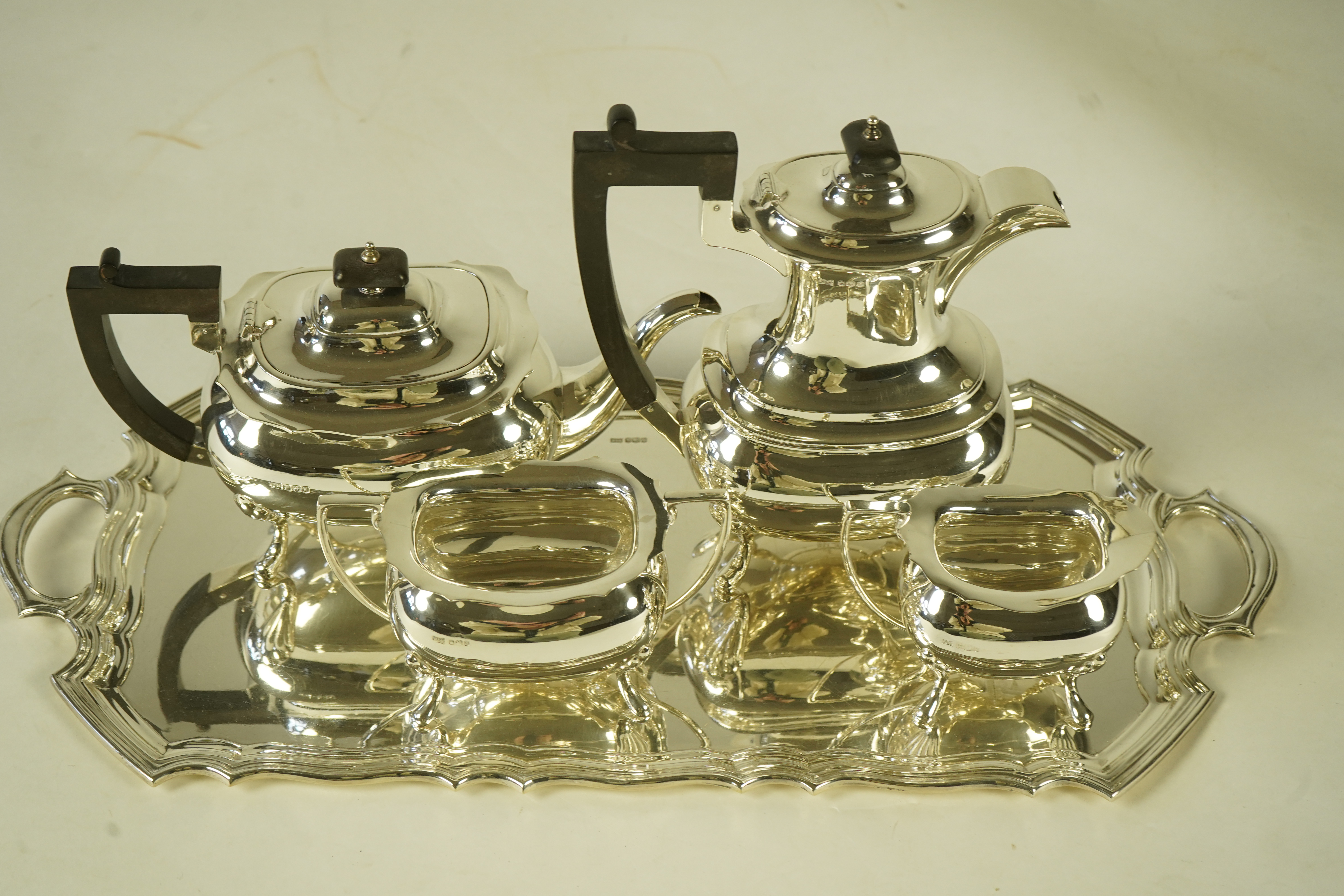 An Elizabeth II silver four piece tea service and two handled tea tray, by Walker & Hall